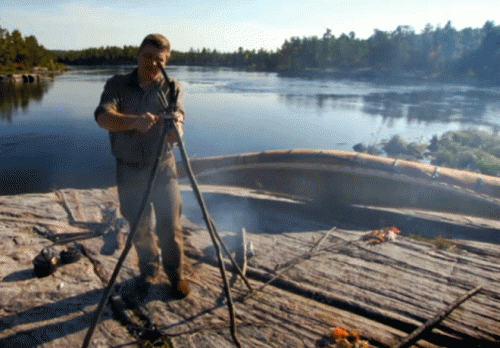 Ray Mears cooking with tripod